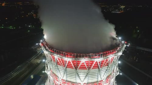 Upper View Steam Pillar Over Modern Cooling Tower in Dusk