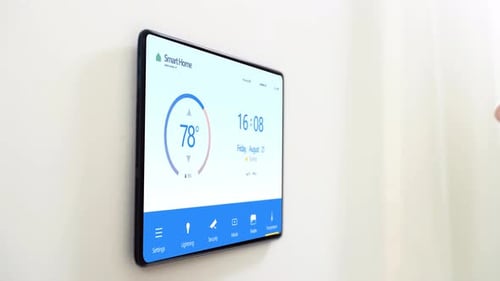 Woman Interacts With Smart Home Device on Wall