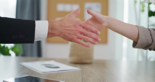 Business Handshake Over Desk Close Up