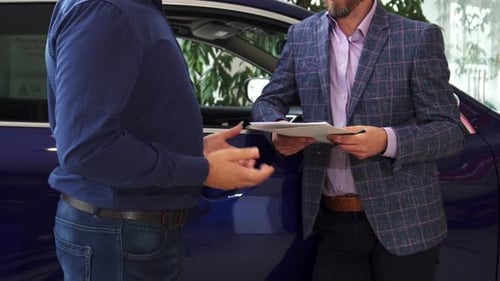 Men Discussing Contract by Car and Shaking Hands