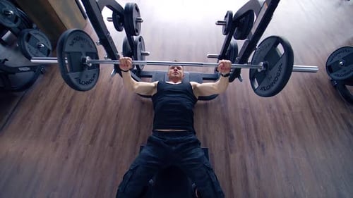 Man doing deadlift exercise at gym. Young man concentrated working at his perfect body