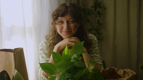 Woman Repotting Plants at Home