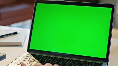 Laptop With Green Screen in an Office Setting