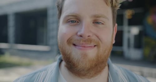 Smiling Young Adult with Blonde Hair and Beard