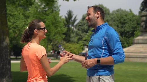 Sportive Couple Resting After Running in City Park, Super 240