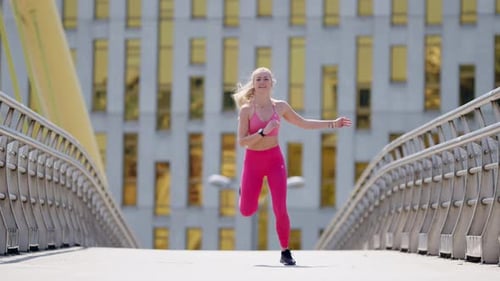 Smiling fit young blonde woman exercises on bridge, wide frontal view