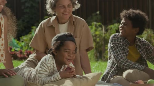 Family and Friends Laughing Together on Lawn