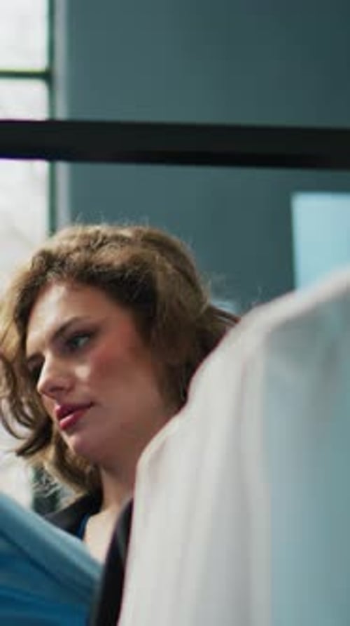 Vertical Video Retail Worker Suggesting Fashion Items to Elderly Customer in Clothing Store