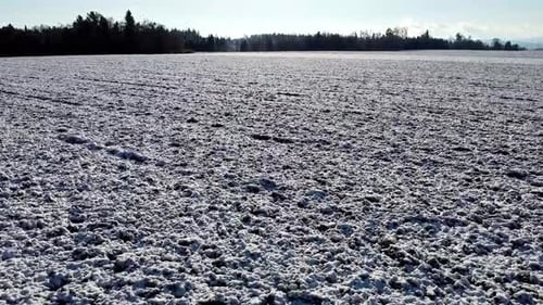 snowy field in winter fast spectacular droneshot
