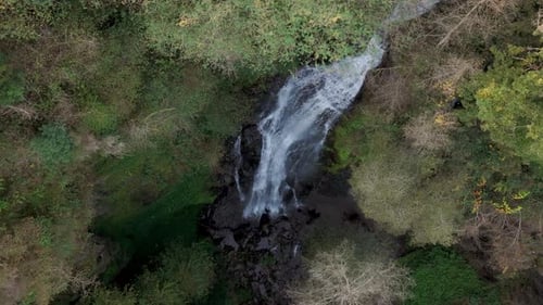Water Flowing Through The Waterfalls In The Forest During Daytime. - aerial shot