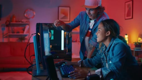 Designers collaborating on a computer project at night