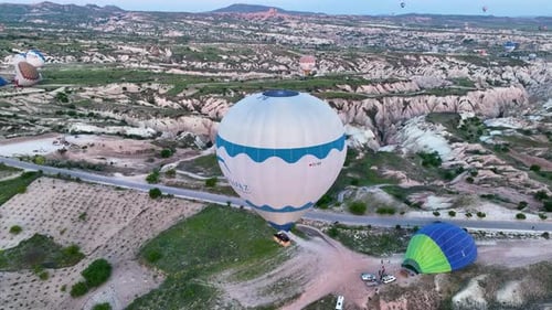 Hot Air Balloons Fly Over the Mountainous Landscape of Cappadocia Turkey