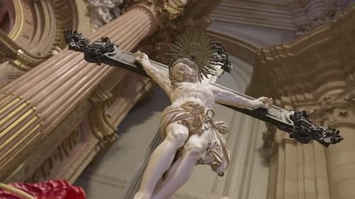 Close-up of Jesus Christ crucifix statue inside ornate historic church