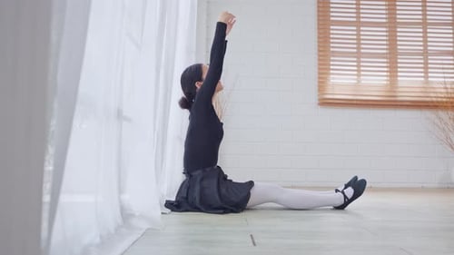 Young Woman Stretching Her Body on the Floor
