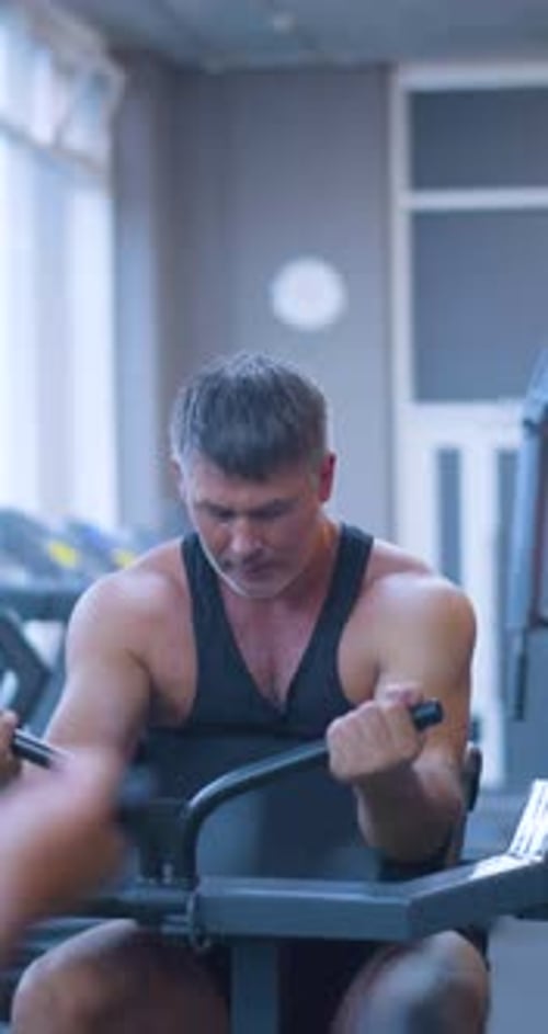 Gym Workout Bicep Exercise Middle Aged Caucasian Man Trains His Bicep Muscles in the Gym