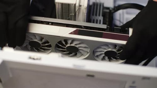 Gloved Hands Installing New Video Card in Computer