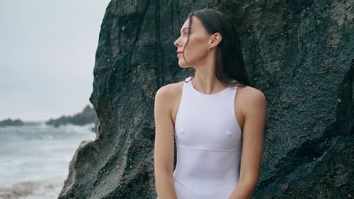 Sensual Young Woman Looking on Beautiful Seascape Leaning at Rock Close Up