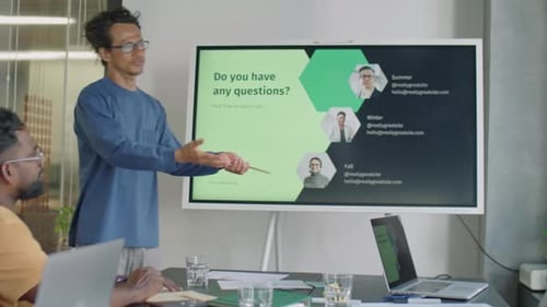 Man Giving Presentation on Business Meeting with Team