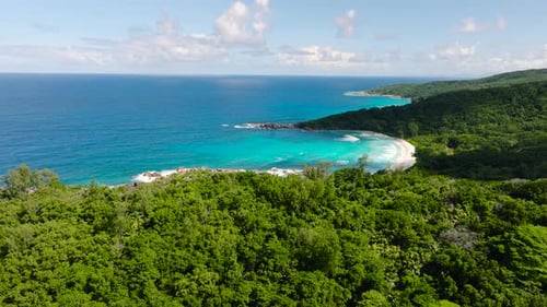 Turquoise Water Beach with Dense Tropical Forest in the Background La Digue Seychelles