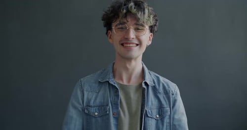 Excited Young Man Raising Arms Smiling
