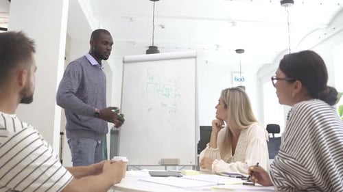 Multicultural Young People Collaborating on Working Strategy in Office