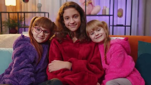 Three Happy Girls in Cozy Blankets Smiling