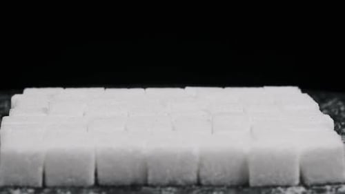 Many Sugar Cubes are Folded in Square Shape Rotate on Black Background CloseUp