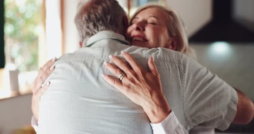 Senior Couple Affectionately Embracing in their Home