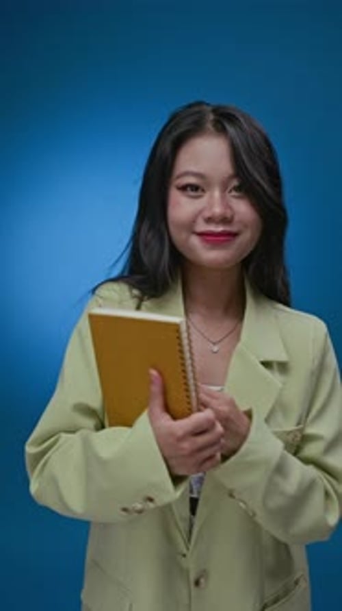Gen Z College Girl Looking at Notebook on Neon Blue Background