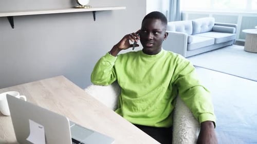 Young Adult Talking on Cell Phone Indoors