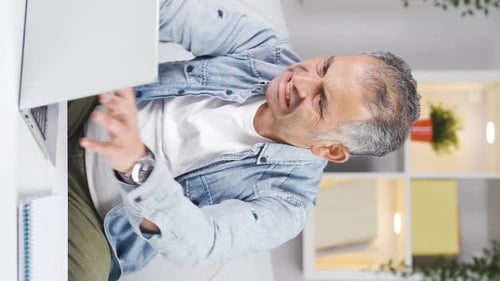 Vertical video of Man exploding with anger.