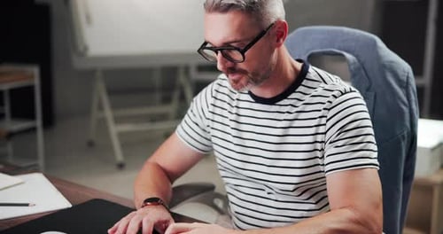 Man Working at Computer in Office Setting