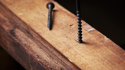 Screw Being Drilled into Plank of Wood