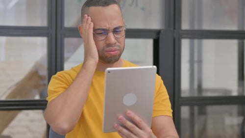 Man Shocked By Tablet News at Workplace