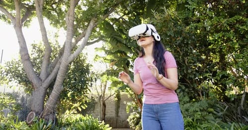 Woman Immersed in Virtual Reality Outdoor Environment