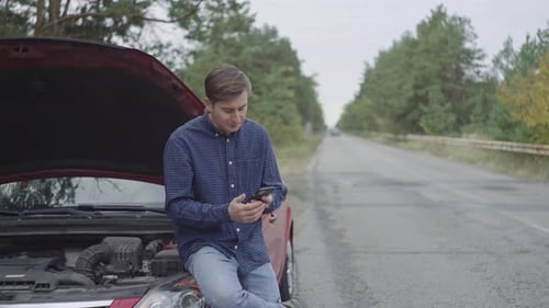 Man Calling for Help with Broken Down Car