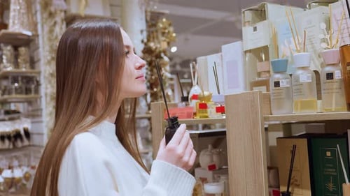 Lady Smelling Perfume in Shopping Mall Testing Fragrance Before Returning