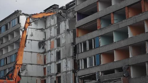 Destruction excavator house demolishing. Demolition building by machine.