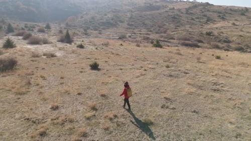 Aerial View Young hiker walking on a mountain path on a sunny day