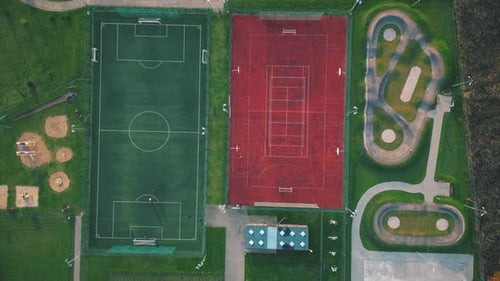 Recreational green grass active sports hockey and football fields overhead top down view. Competitio