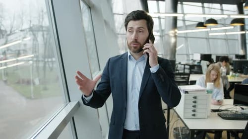 Closeup View of Young Entrepreneur Discussing Business While Having a Call