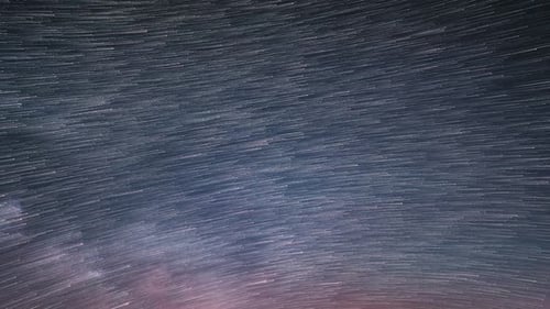 Startrails of Stars in Starry Night Sky with Milky Way Galaxy Trails Background Astronomy Time Lapse