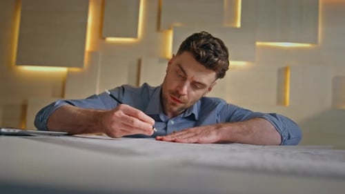 Professional Builder Writing Draft in Modern Architectural Agency Close Up