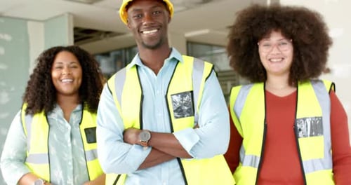 Portrait of smiling casual diverse architects working in office, slow motion with copy space