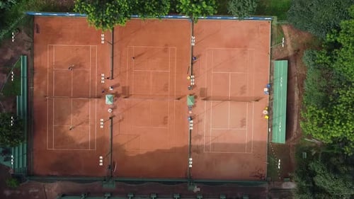 Zenithal shot with travelling in of a tennis clay court.