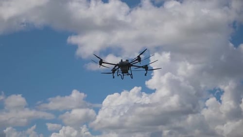 Drone Flies High in the Sky Above Clouds