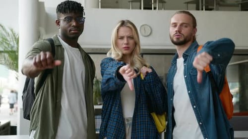 Three Multiracial Friends Diversity Students Showing Thumbs Down Negative Dissatisfied Bad Dislikes