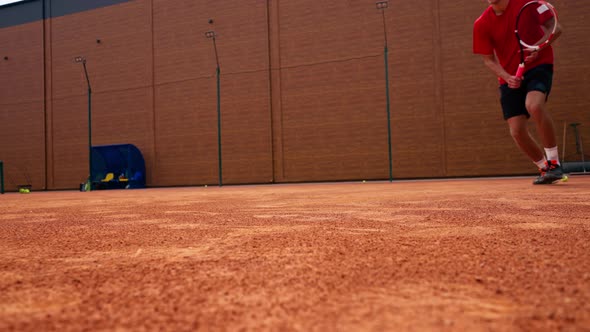 close-up of a tennis player's leg in dust on a tennis court who hits an ...
