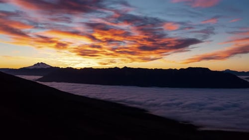 Time-lapse of the sun setting over the National Park Vicente Perez Rosales, golden orange sky.