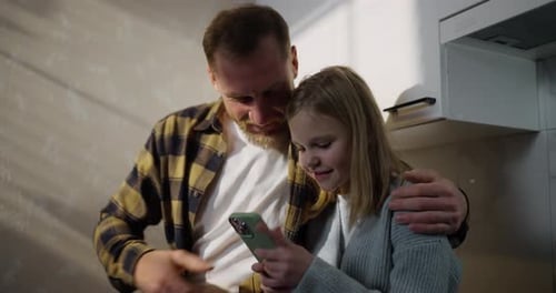 Father and Child Enjoying Smart Phone Together